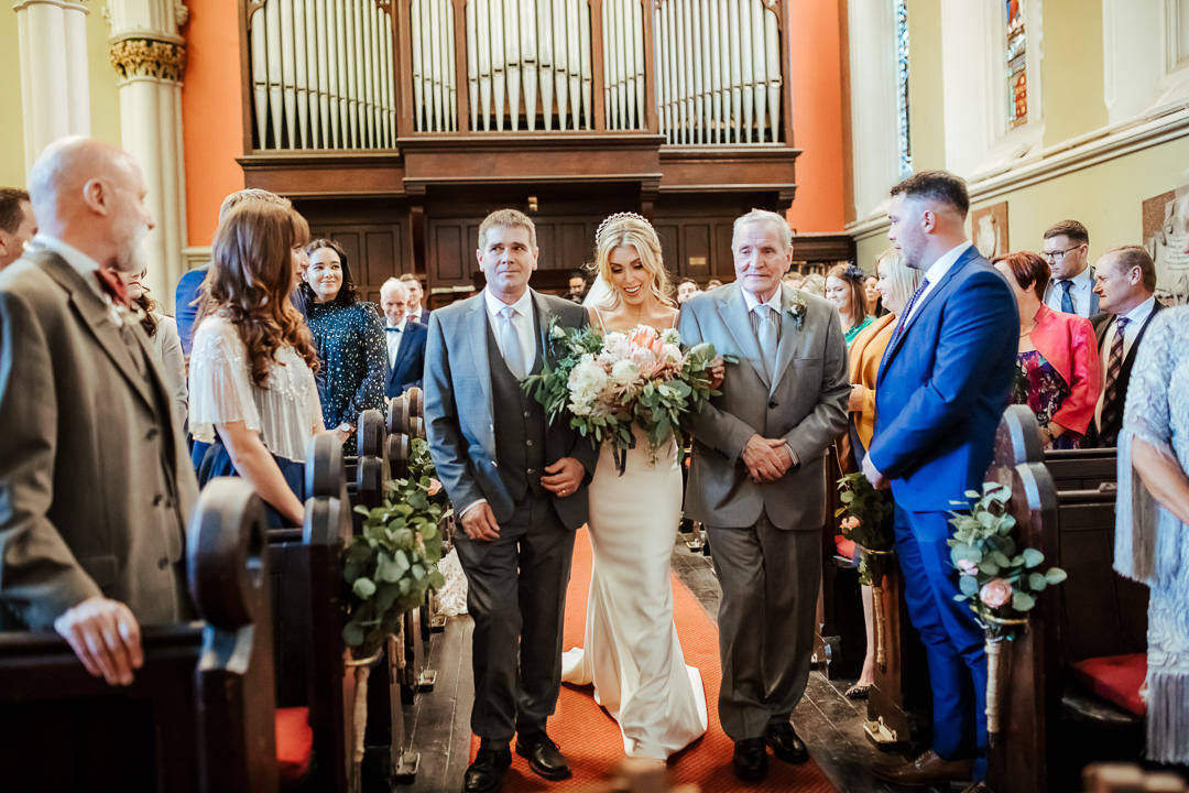 bride walking up the aisle with her father and grandfather at unitarian church dublin