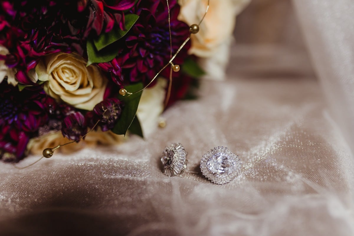 Wedding details, bridal diamond earrings on the wedding veil
