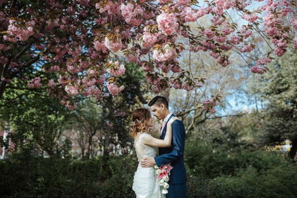 bride and groom under cherry blossoms 