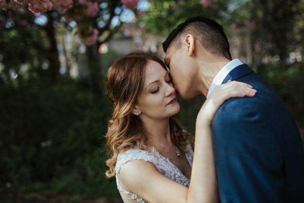 tender kisses bride and groom wedding portrait