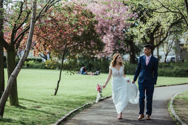 bride and groom walking in merrion square park dublin