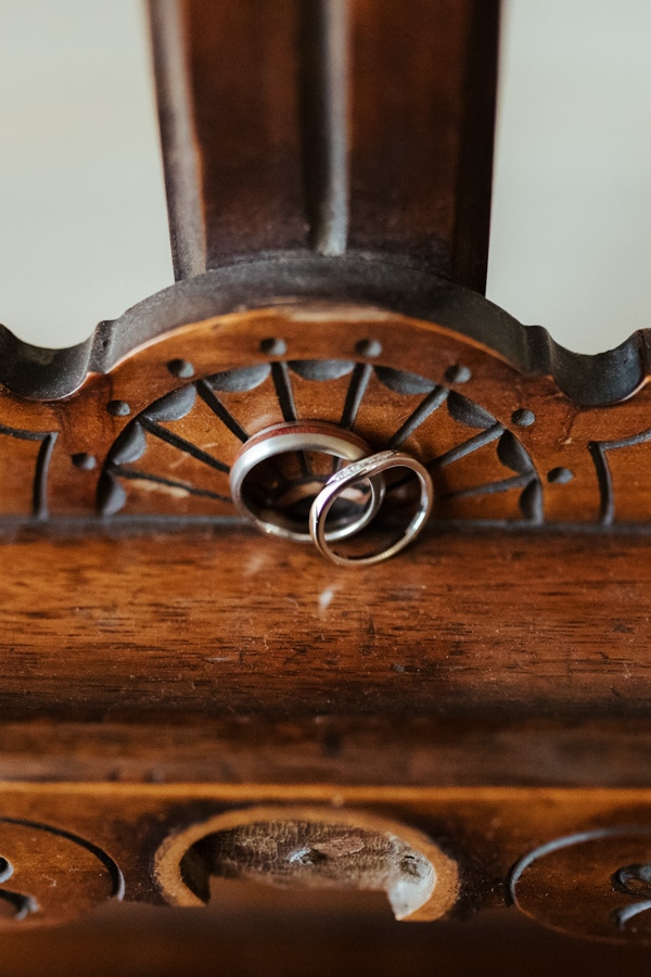 white gold wedding rings on wooden surface