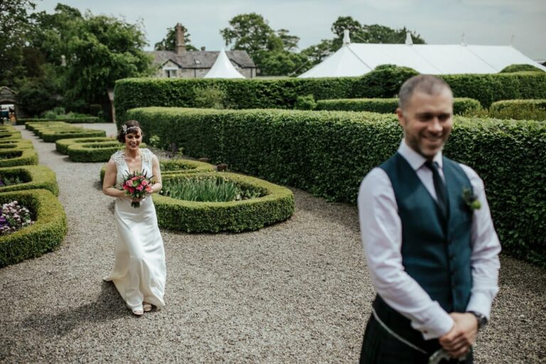bride walking to meet groom for first look at secret garden in martinstown house kildare ireland
