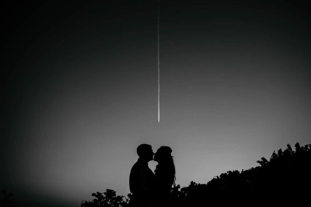 couple kissing under shooting stars