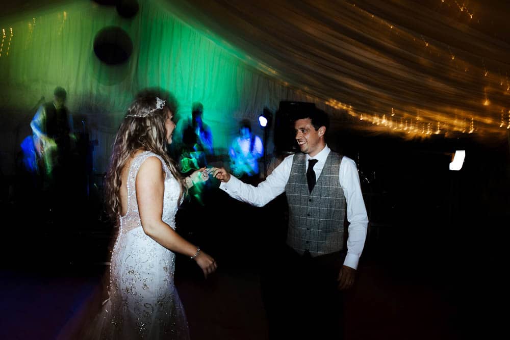 bride and groom first dance in marquee