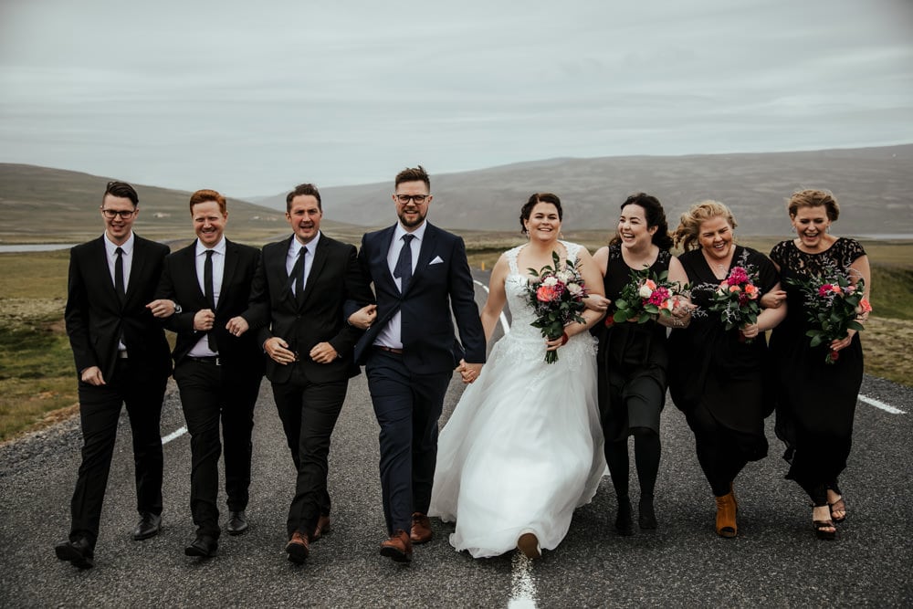 bridal party in black in the middle of the road in iceland