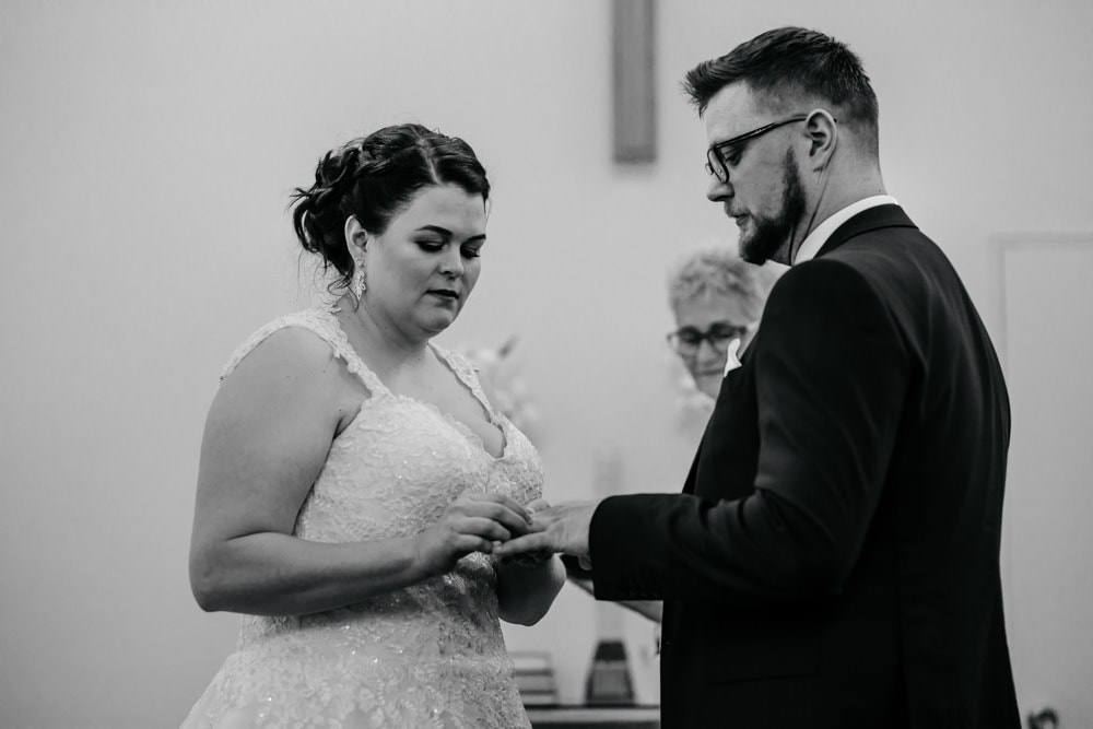 bride and groom exchanging rings church wedding in iceland