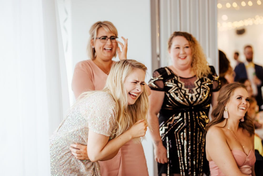 bridesmaids laughing during wedding speeches