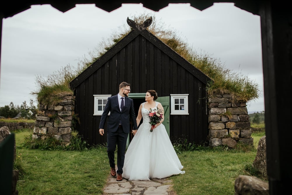 wedding couple in front of a traditional icelandic turf church