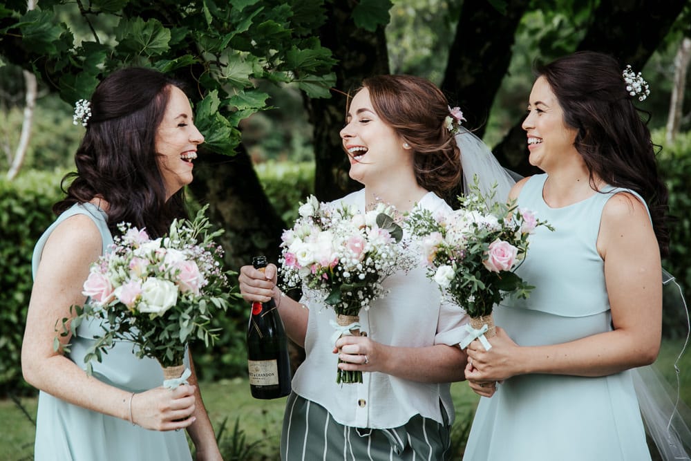 bride having a laugh with her bridesmaids