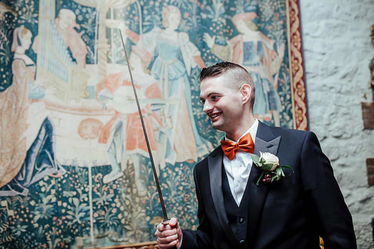 groom holding a real sword barberstown castle wedding