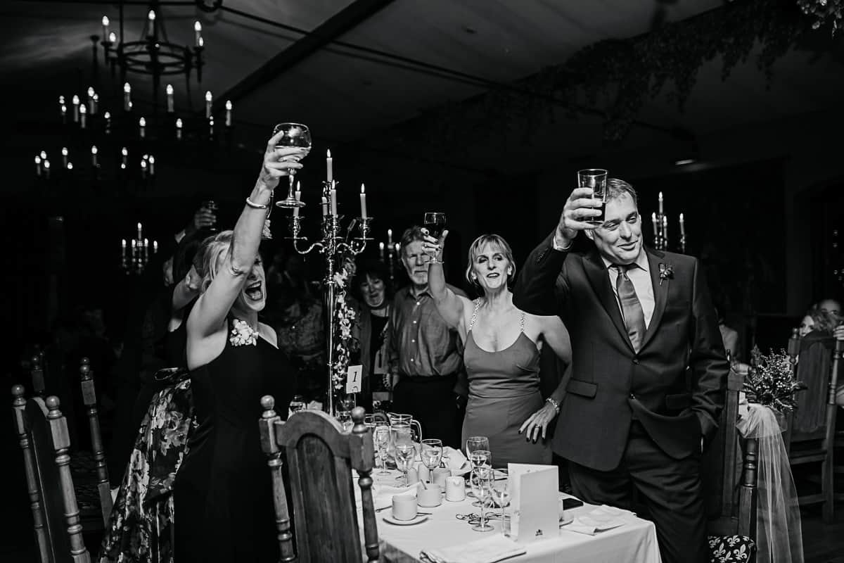 guests toasting the newlyweds at wedding reception dinner