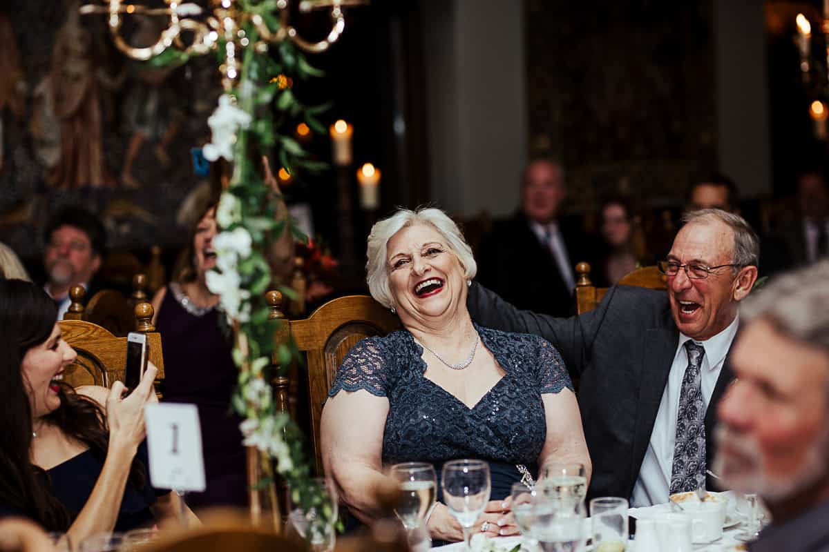 candid photo of guests laughing at a wedding