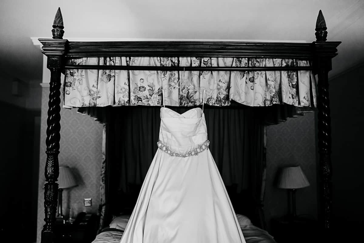 wedding dress hanging on a four poster bed barberstown castle wedding