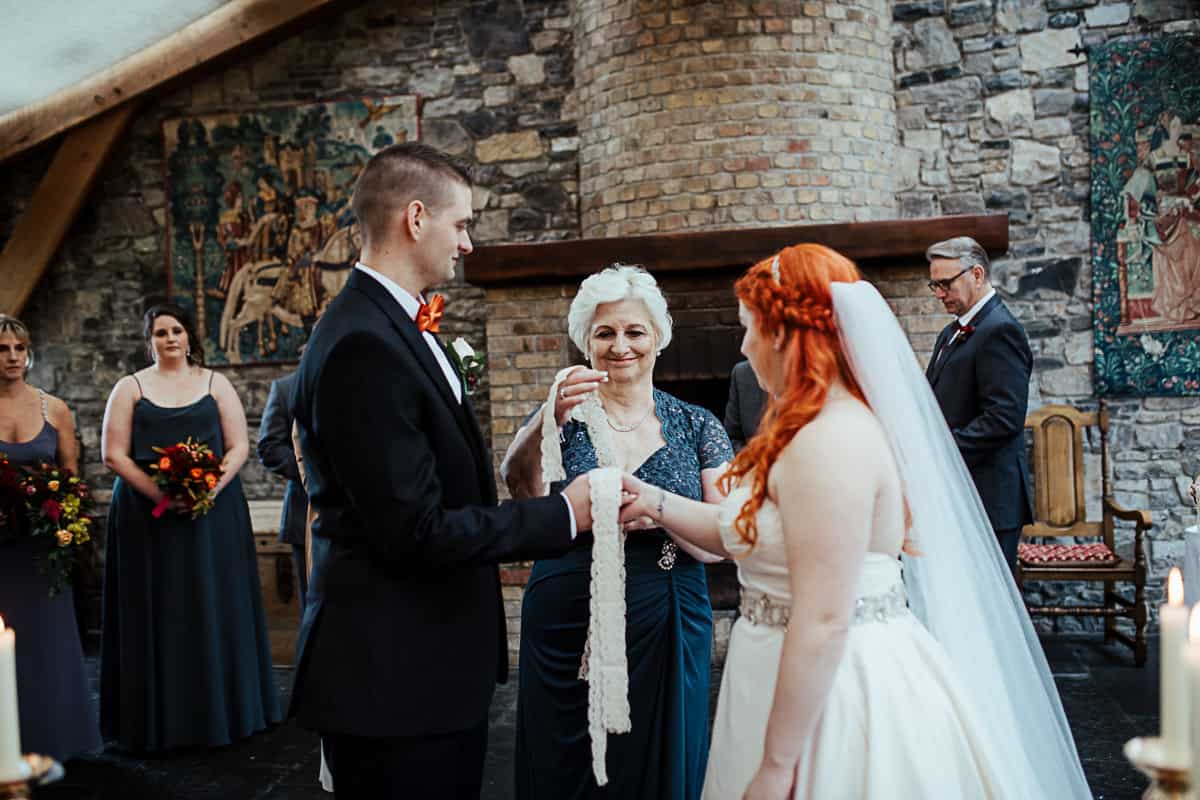 bride's grandmother tying the knot in handfasting wedding ceremony