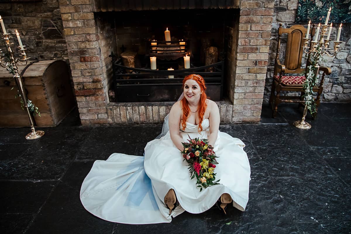 happy bride sitting on the floor after wedding ceremony