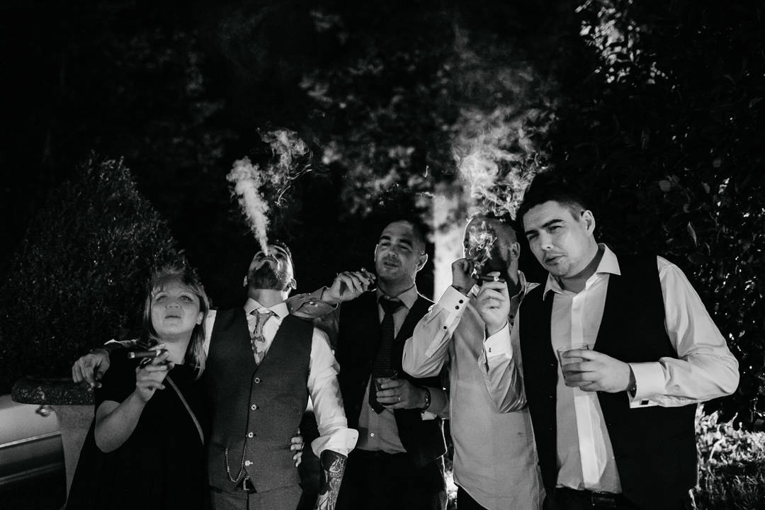 groom smoking cuban cigars on the evening of his wedding