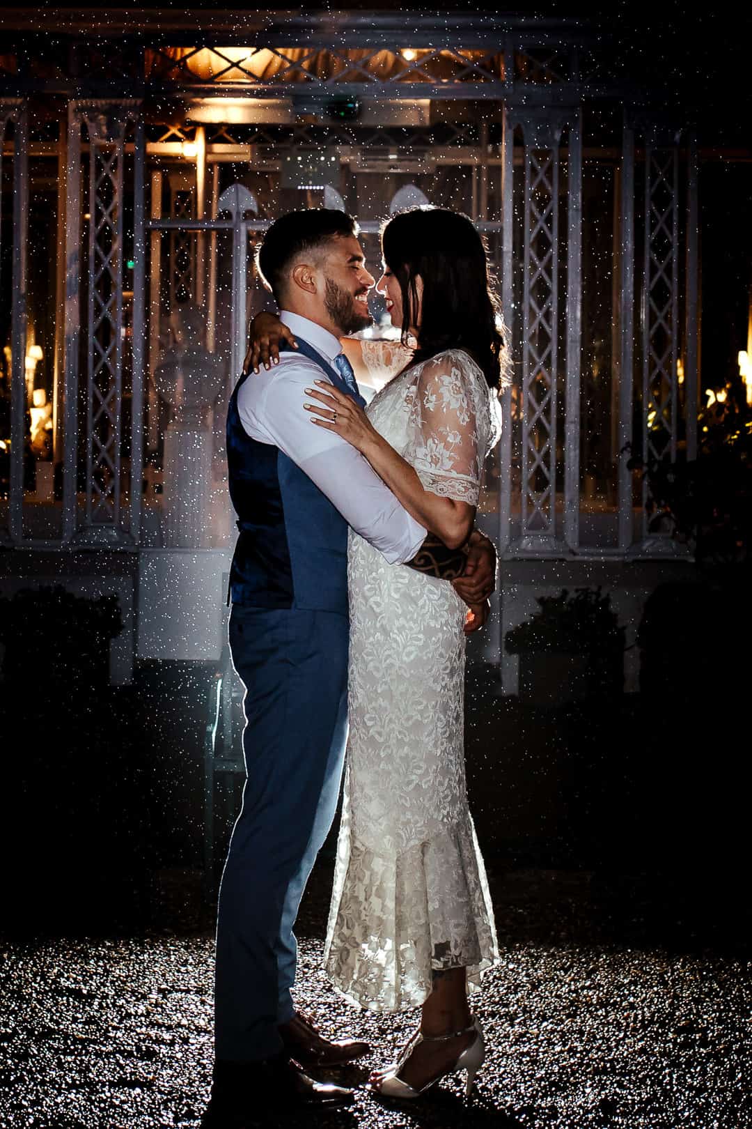 couple kissing in the rain at night creative wedding photography ireland