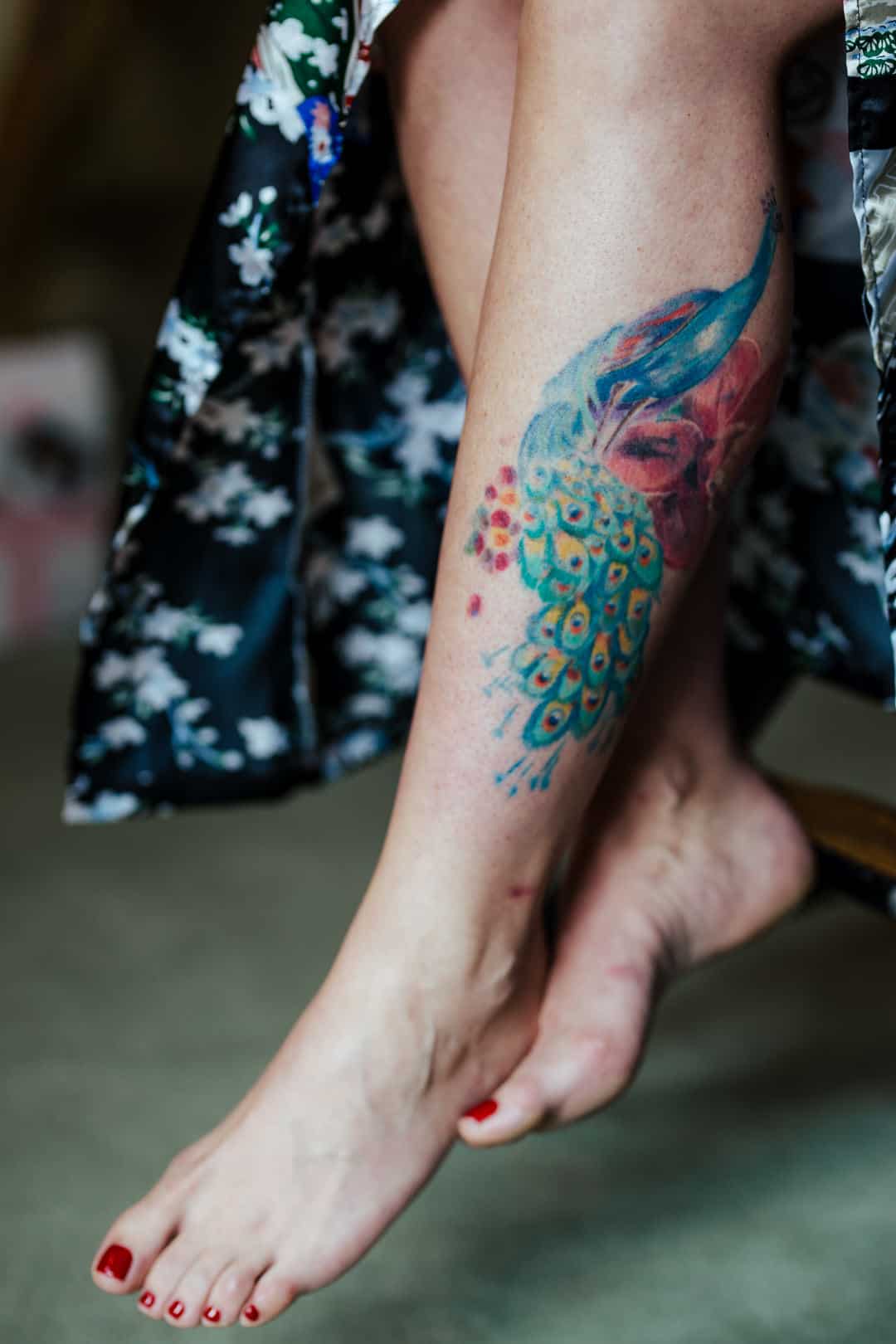tatoo of a peacock on a woman's leg