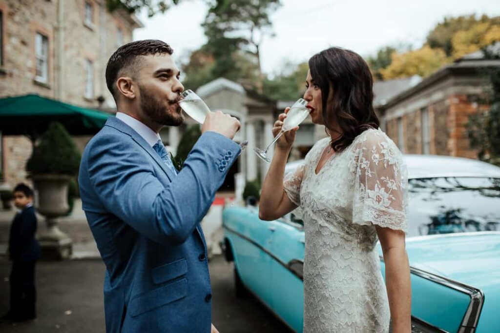 bride and groom enjoying a glass of prosecco for their wedding reception at marlfield house