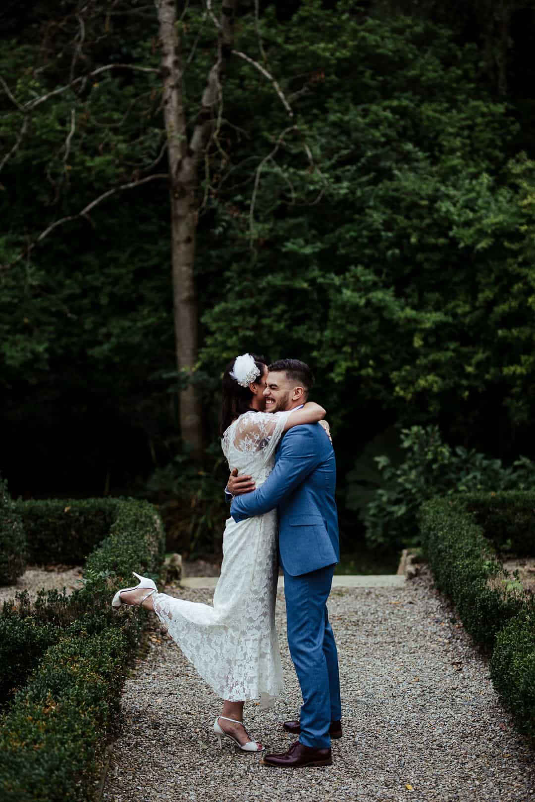 bride and groom hugging in marlfield house gardens candid wedding photographer ireland