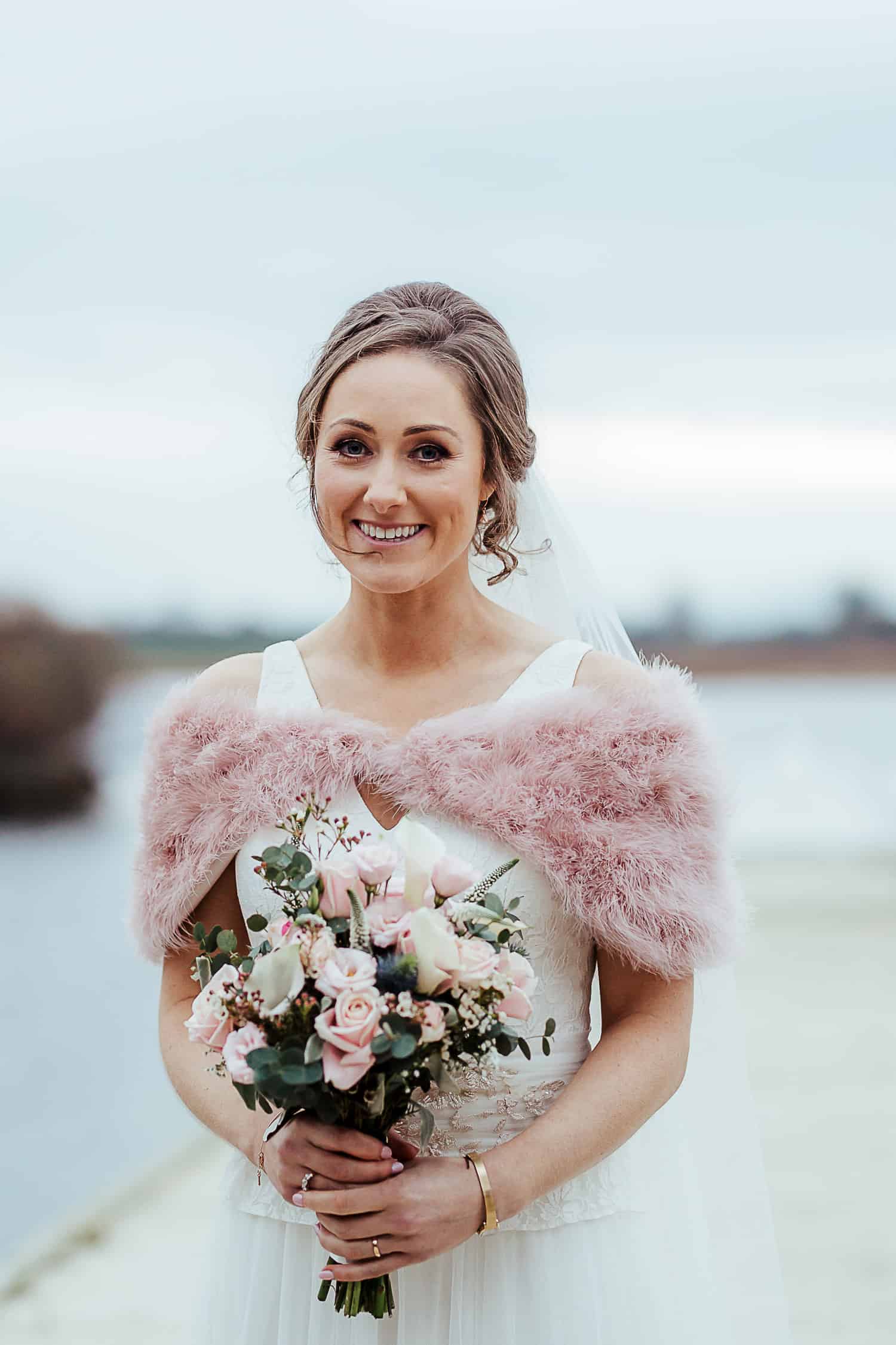 bride in pink ostrich winter coat ashley park house wedding