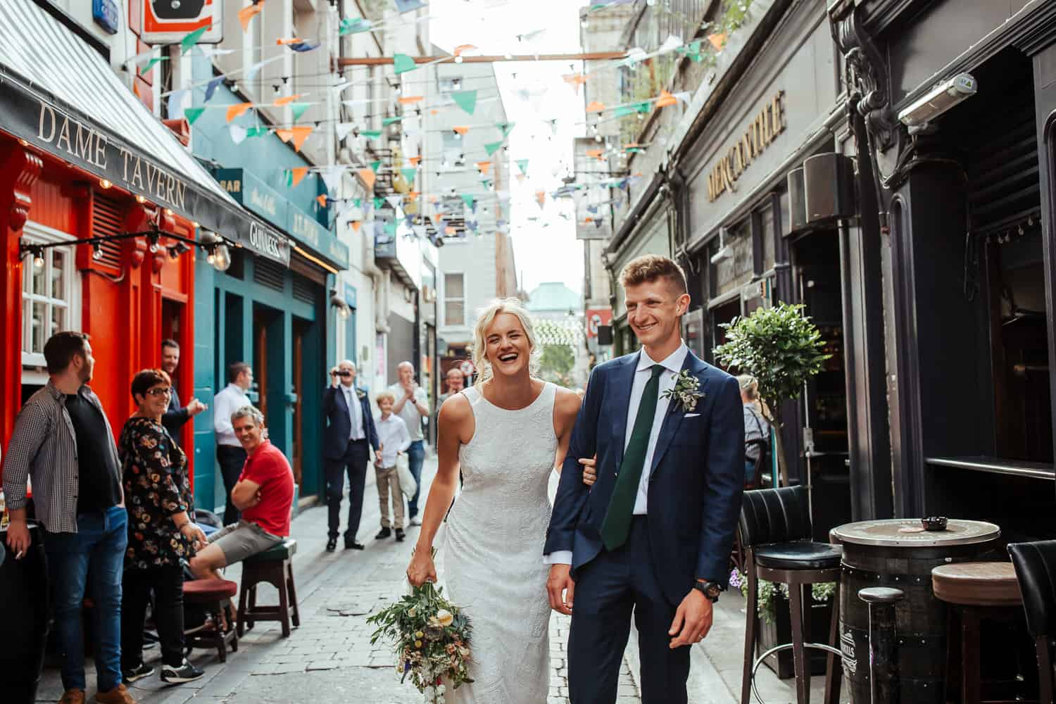 bride and groom walking through the streets of dublin