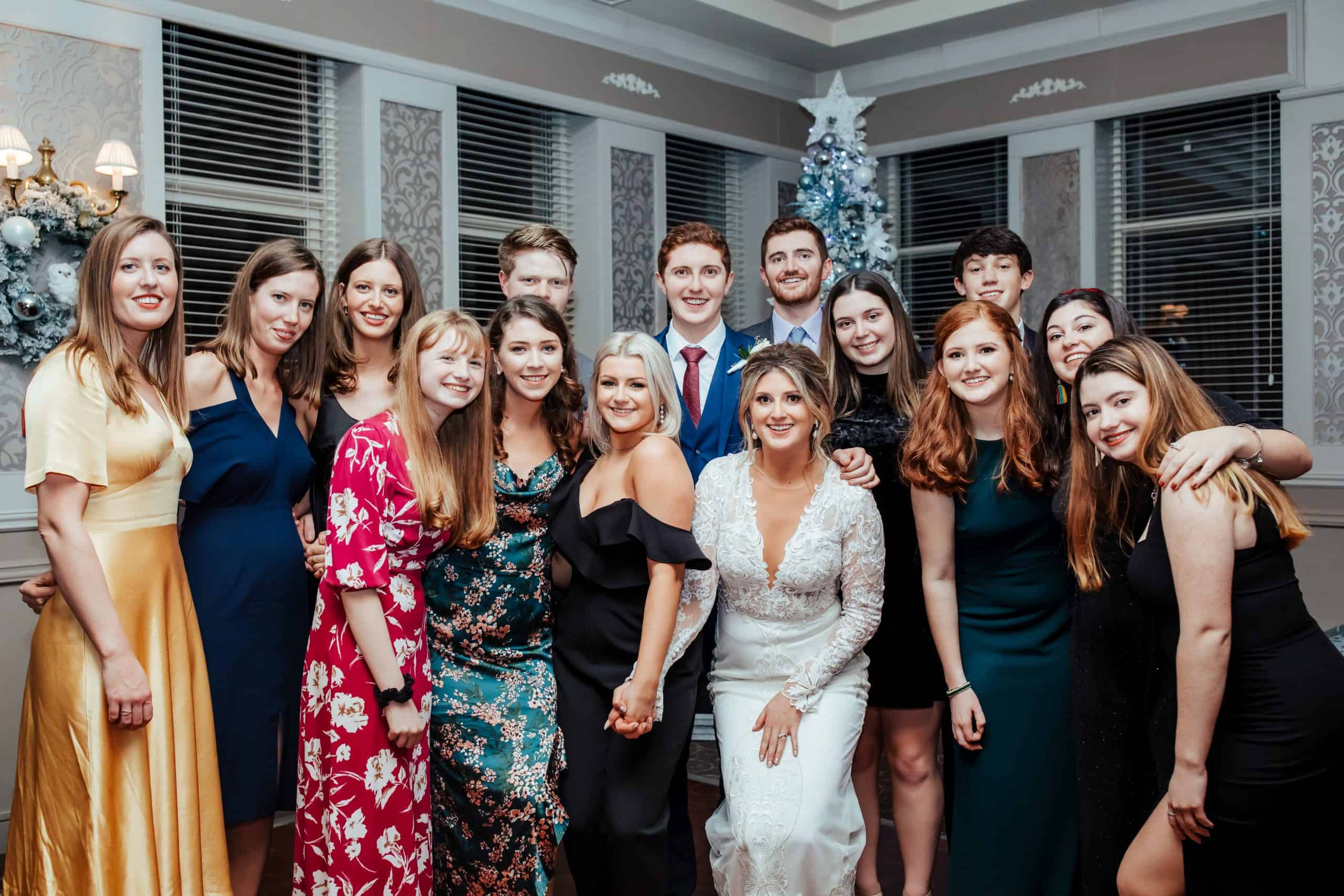 group photo with friends at christmas wedding