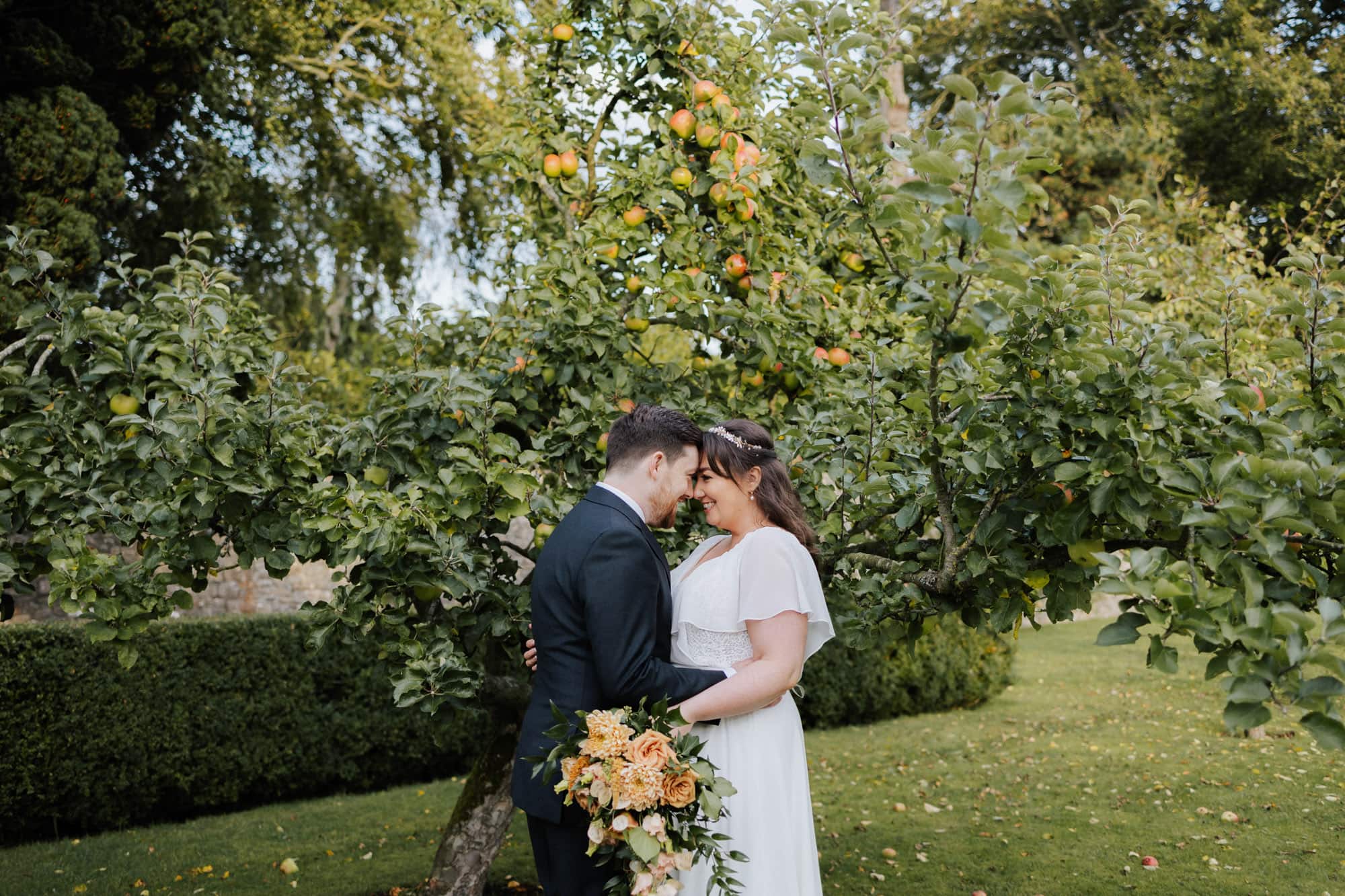 wedding couple in the orchard at ballymagarvey village